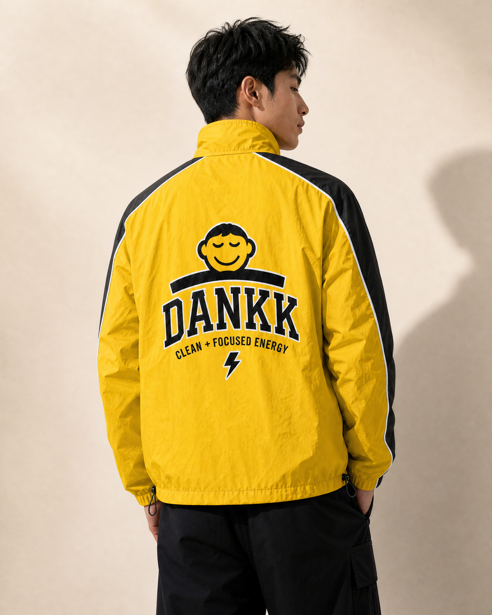 Yellow DANKK varsity jacket, back view with DANKK chenille lettering