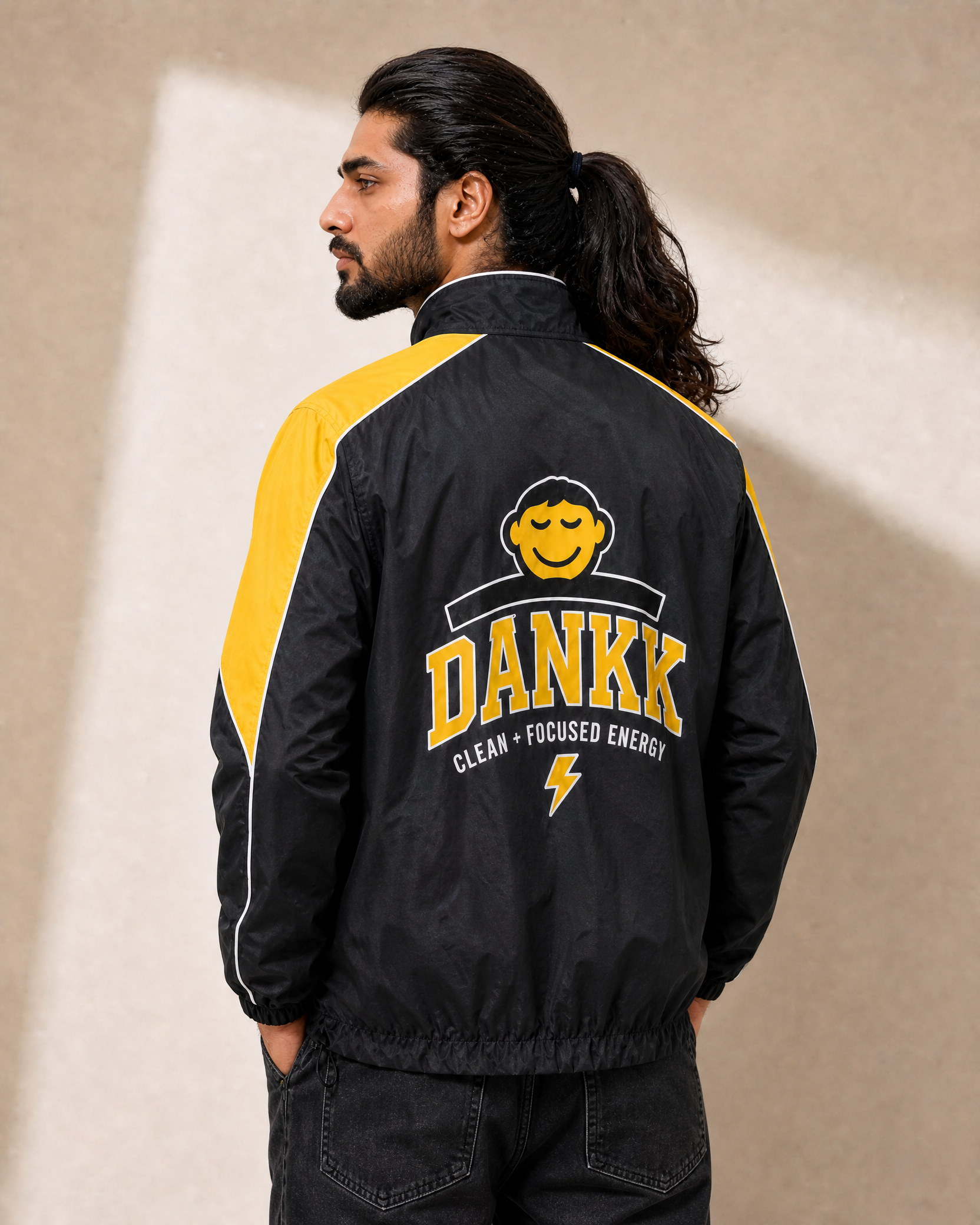 Black DANKK varsity jacket, back view with DANKK chenille lettering