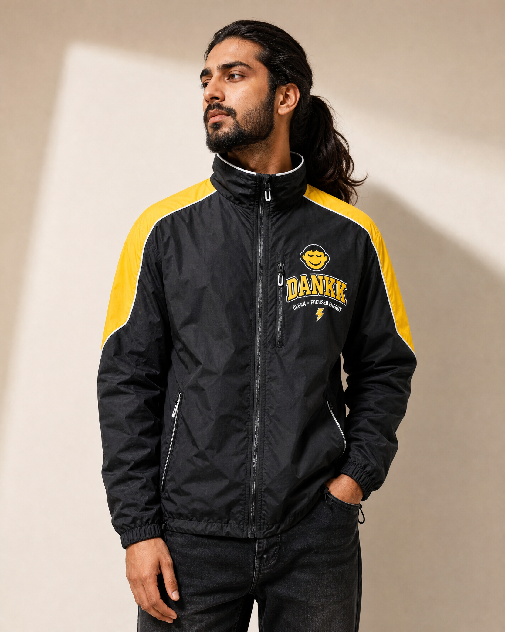 Model wearing the black DANKK varsity jacket, front view